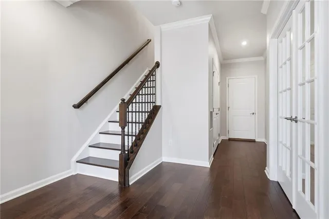 a view of a hallway with wooden floor and stairs