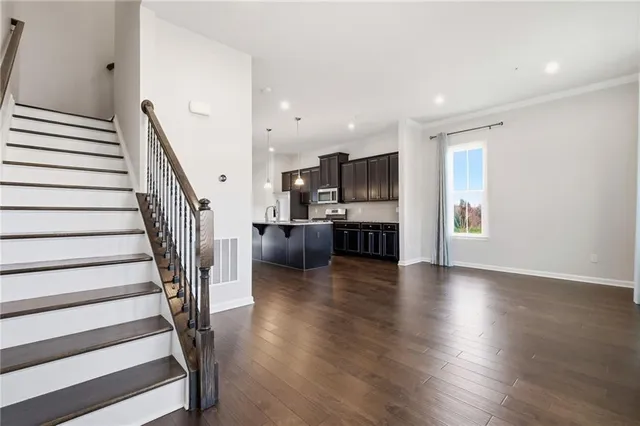 a view of a kitchen with wooden floor and a kitchen