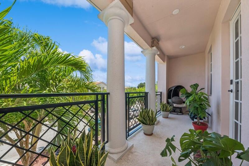 8292 Northwest 9th Avenue Boca Raton, FL 33487 - Photo 11 of 15 a porch with chairs and potted plants