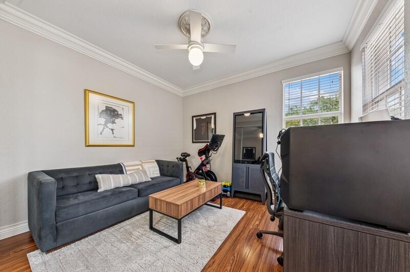 8292 Northwest 9th Avenue Boca Raton, FL 33487 - Photo 13 of 15 a living room with furniture a window and a chandelier
