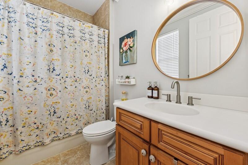 8292 Northwest 9th Avenue Boca Raton, FL 33487 - Photo 14 of 15 a bathroom with a sink a toilet and a mirror