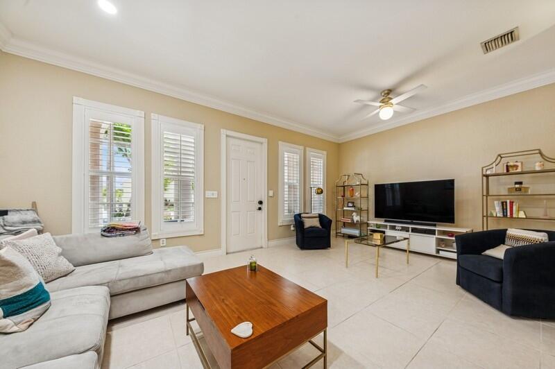 8292 Northwest 9th Avenue Boca Raton, FL 33487 - Photo 4 of 15 a living room with furniture and a flat screen tv