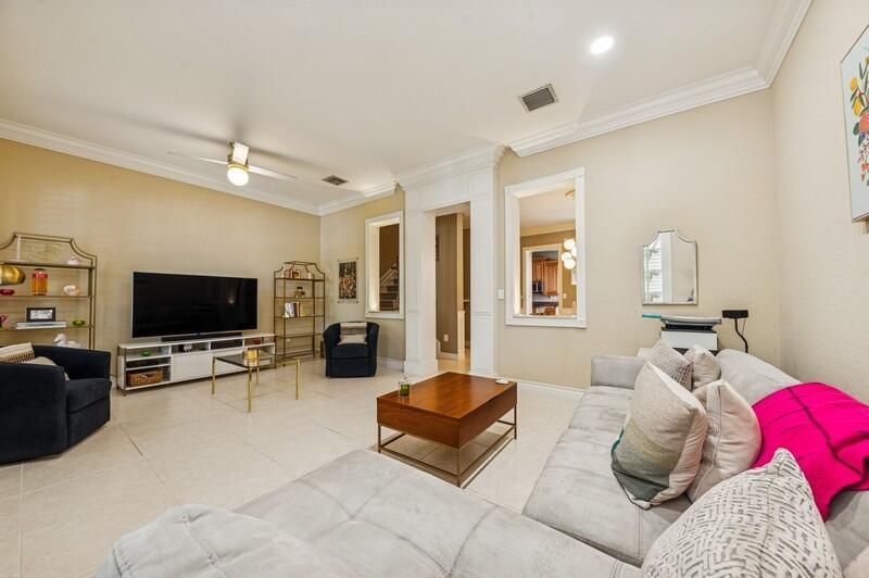 8292 Northwest 9th Avenue Boca Raton, FL 33487 - Photo 5 of 15 a living room with furniture and a flat screen tv