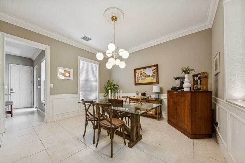 8292 Northwest 9th Avenue Boca Raton, FL 33487 - Photo 7 of 15 a view of a dining room with furniture and chandelier