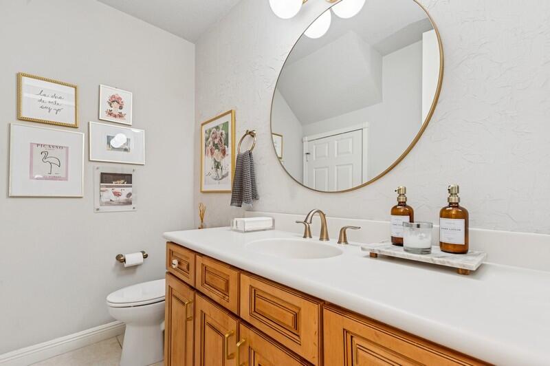 8292 Northwest 9th Avenue Boca Raton, FL 33487 - Photo 9 of 15 a bathroom with a sink a toilet and a mirror