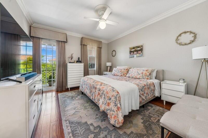 8292 Northwest 9th Avenue Boca Raton, FL 33487 - Photo 10 of 15 a spacious bedroom with a bed and a flat screen tv