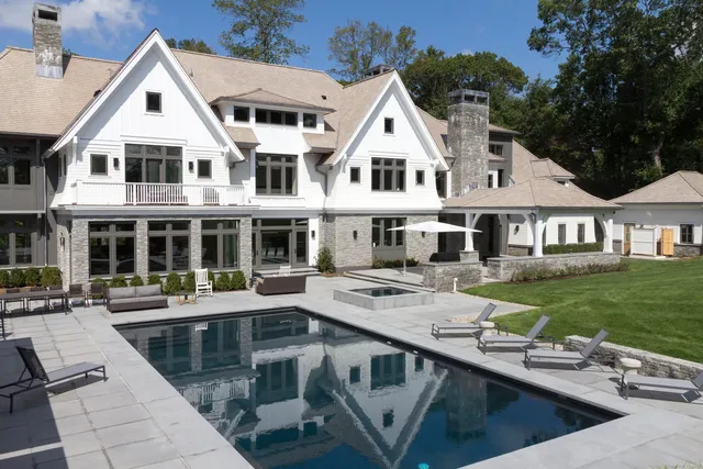 a aerial view of a house with swimming pool and porch