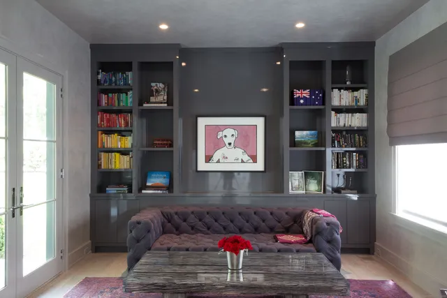 a living room with furniture and a book shelf