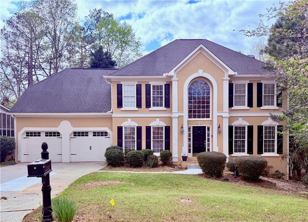 3830 Peachbluff Court Duluth, GA 30097 - Photo 1 of 39 a front view of a house with yard and green space
