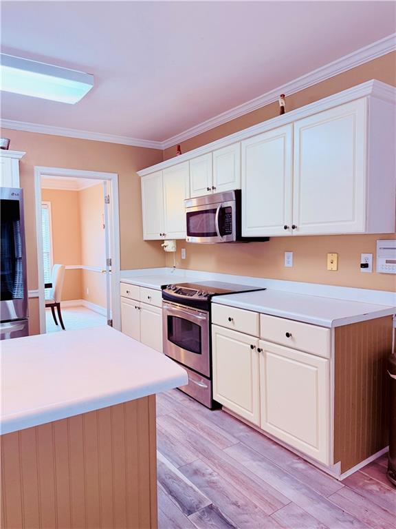 3830 Peachbluff Court Duluth, GA 30097 - Photo 15 of 39 a kitchen with kitchen island a sink cabinets and wooden floor