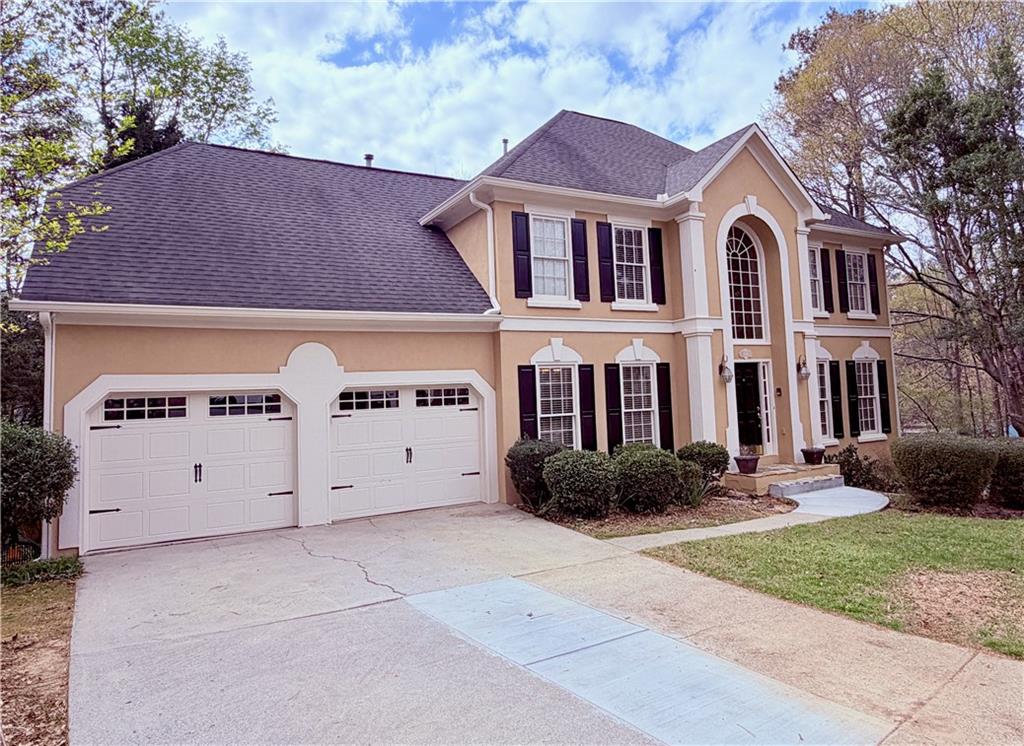 3830 Peachbluff Court Duluth, GA 30097 - Photo 2 of 39 a front view of a house with garden