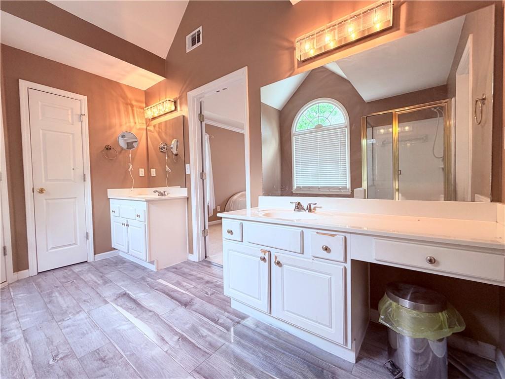 3830 Peachbluff Court Duluth, GA 30097 - Photo 23 of 39 a spacious bathroom with a vanity a sink and a large mirror