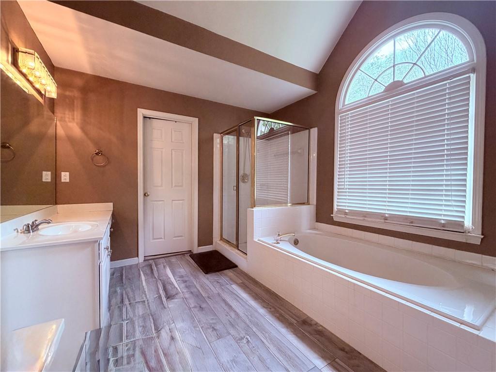 3830 Peachbluff Court Duluth, GA 30097 - Photo 24 of 39 a bathroom with a bathtub and a sink