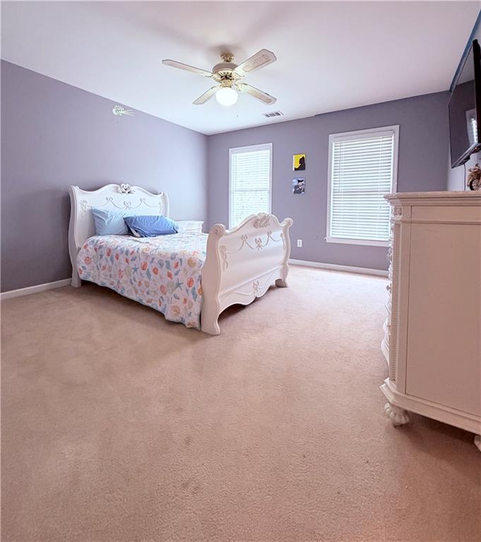 3830 Peachbluff Court Duluth, GA 30097 - Photo 25 of 39 a spacious bedroom with a bed and a chandelier