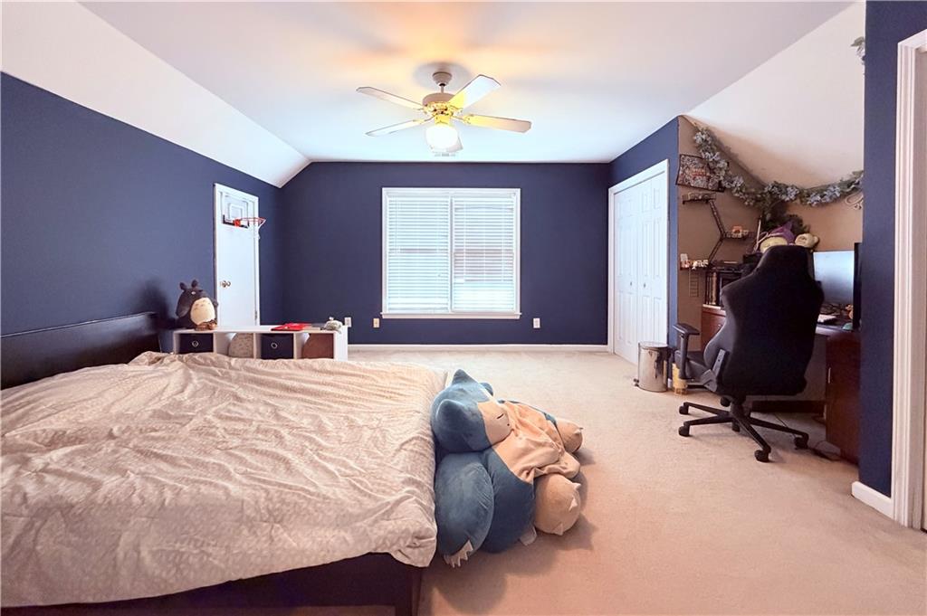3830 Peachbluff Court Duluth, GA 30097 - Photo 27 of 39 a bed room with a bed and a chair