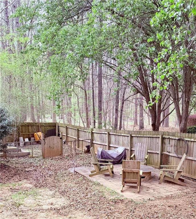 3830 Peachbluff Court Duluth, GA 30097 - Photo 36 of 39 a backyard of a house with table and chairs