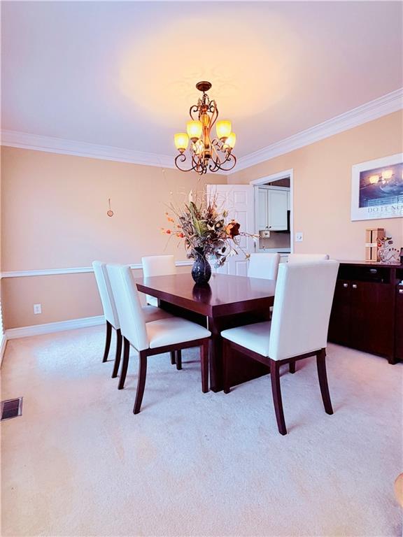 3830 Peachbluff Court Duluth, GA 30097 - Photo 8 of 39 a view of a dining room with furniture and a chandelier