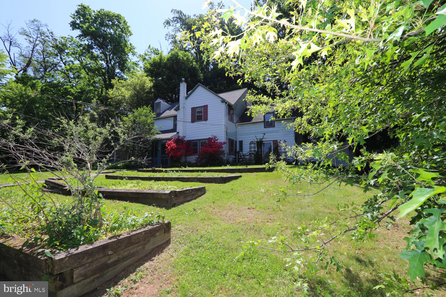 2701 Alden Road Bryn Athyn, PA 19006 - Photo 8 of 105 a front view of a house with a yard table and chairs