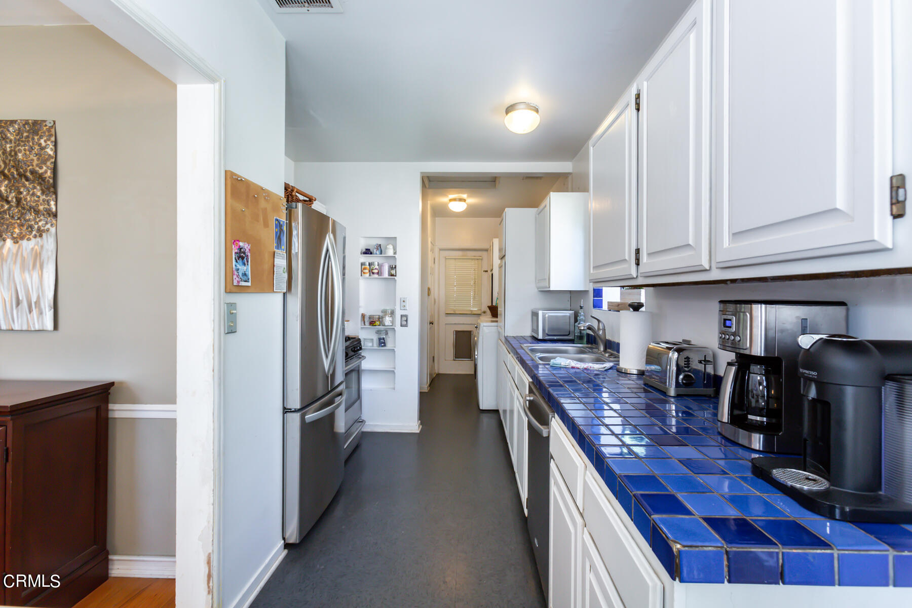 781 Morada Place Altadena, CA 91001 - Photo 18 of 41 a kitchen with stainless steel appliances granite countertop a refrigerator and a stove top oven
