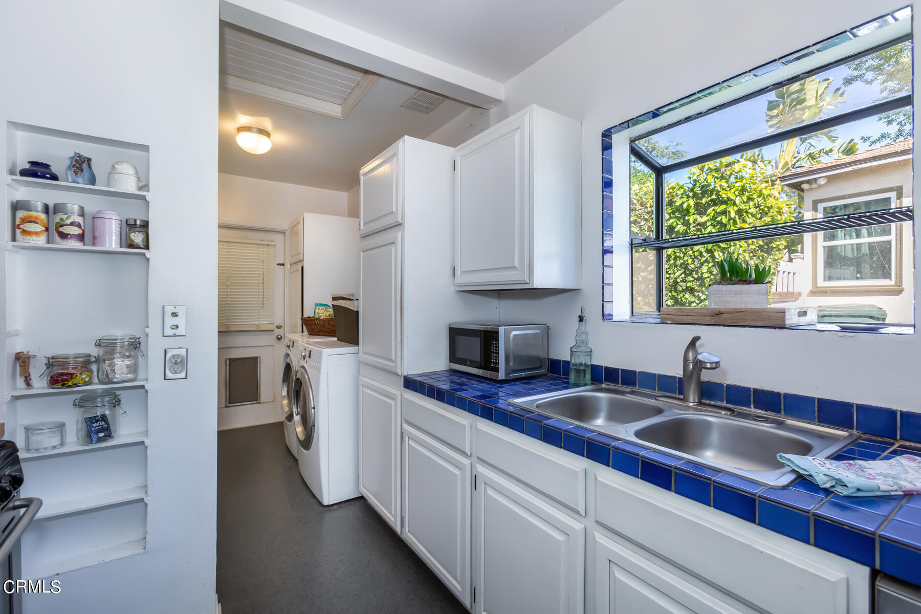 781 Morada Place Altadena, CA 91001 - Photo 23 of 41 a kitchen with stainless steel appliances sink a window and cabinets