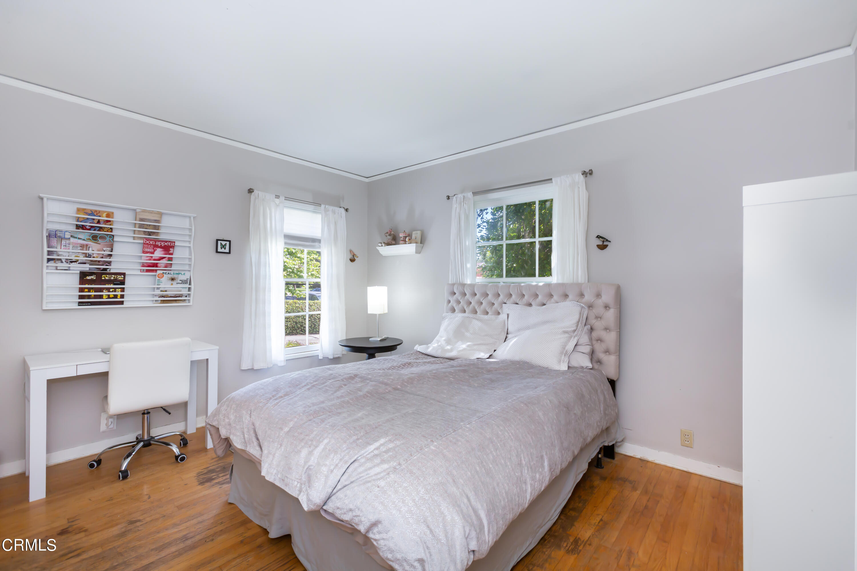 781 Morada Place Altadena, CA 91001 - Photo 27 of 41 a bedroom with a bed a table and a window