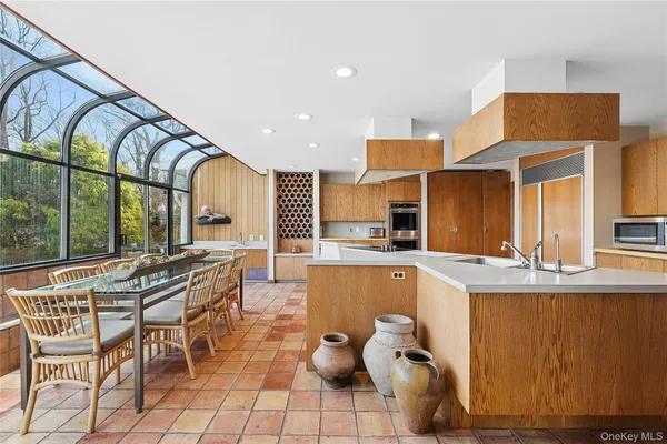 a large kitchen with stainless steel appliances granite countertop a refrigerator and a sink