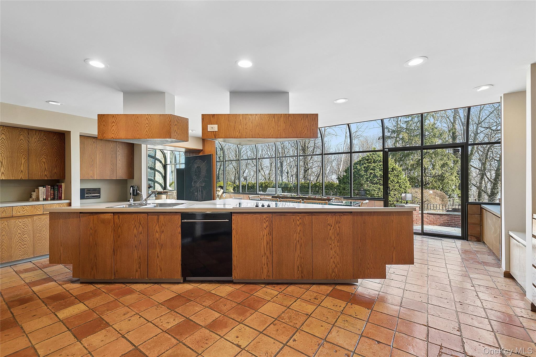 45 SE Road Sands Point, NY 11050 - Photo 14 of 36 a large kitchen with stainless steel appliances granite countertop a refrigerator and a sink