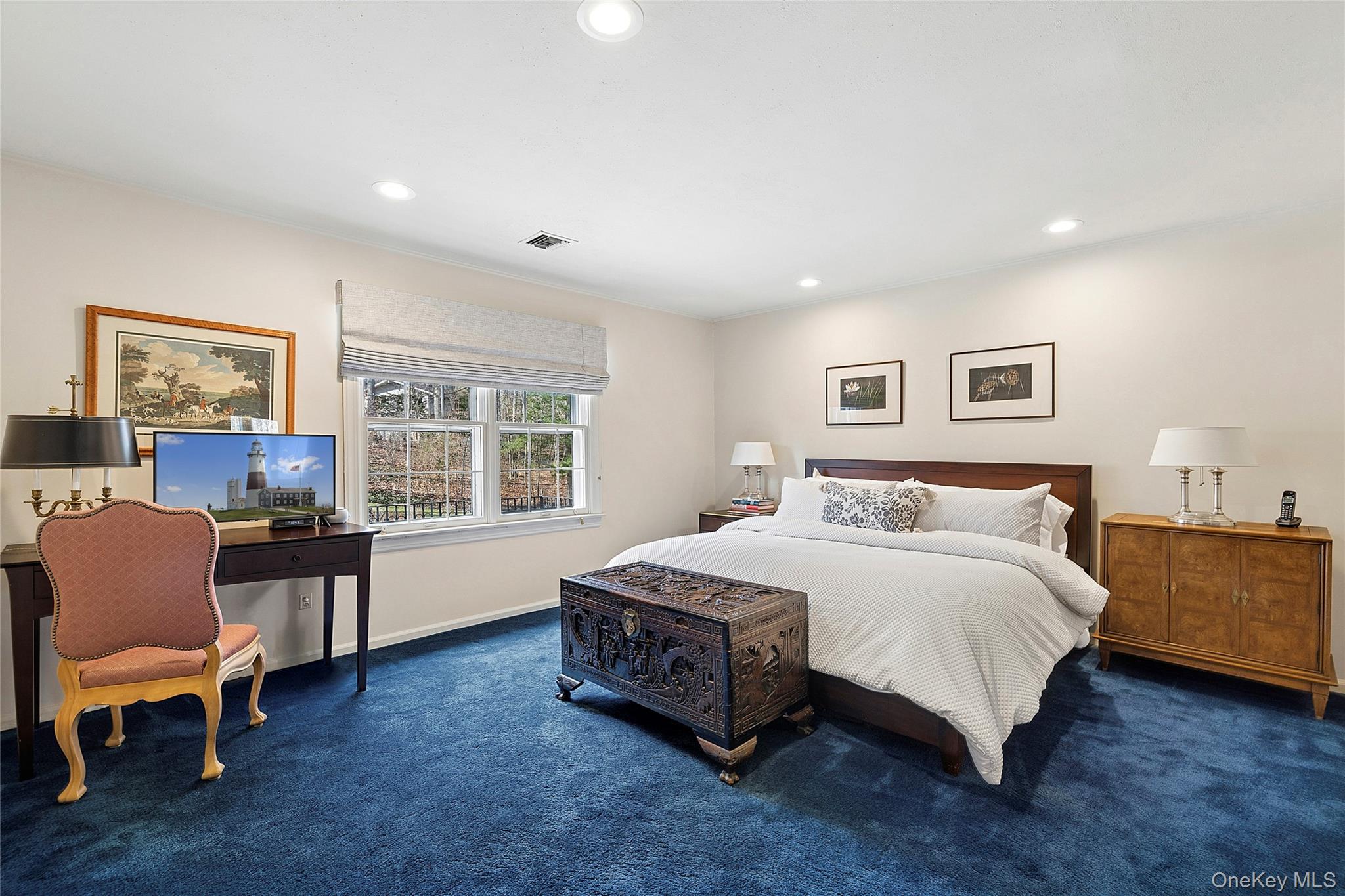 45 SE Road Sands Point, NY 11050 - Photo 18 of 36 a spacious bedroom with a bed and a couch