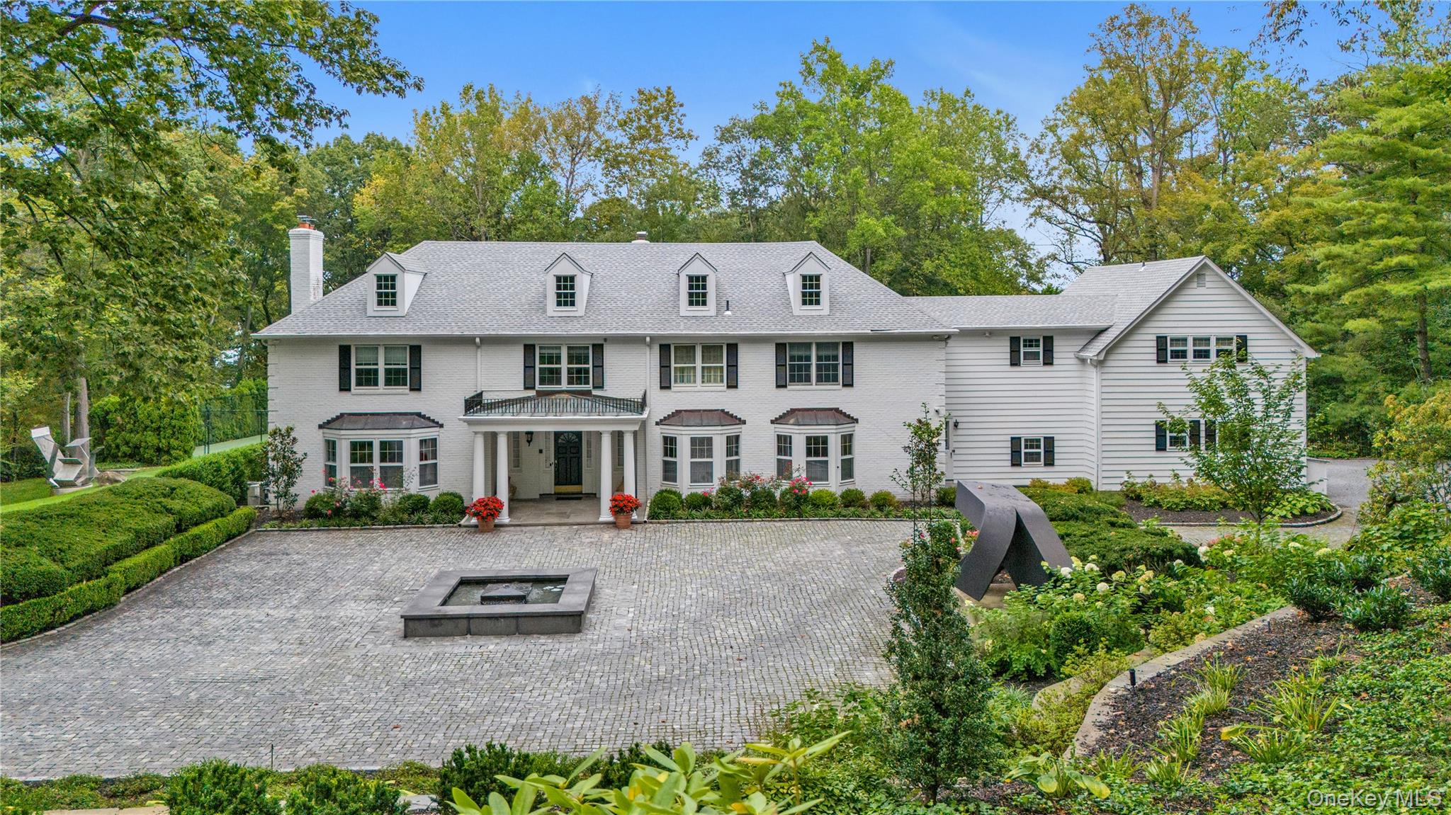 45 SE Road Sands Point, NY 11050 - Photo 2 of 36 a front view of a house with garden