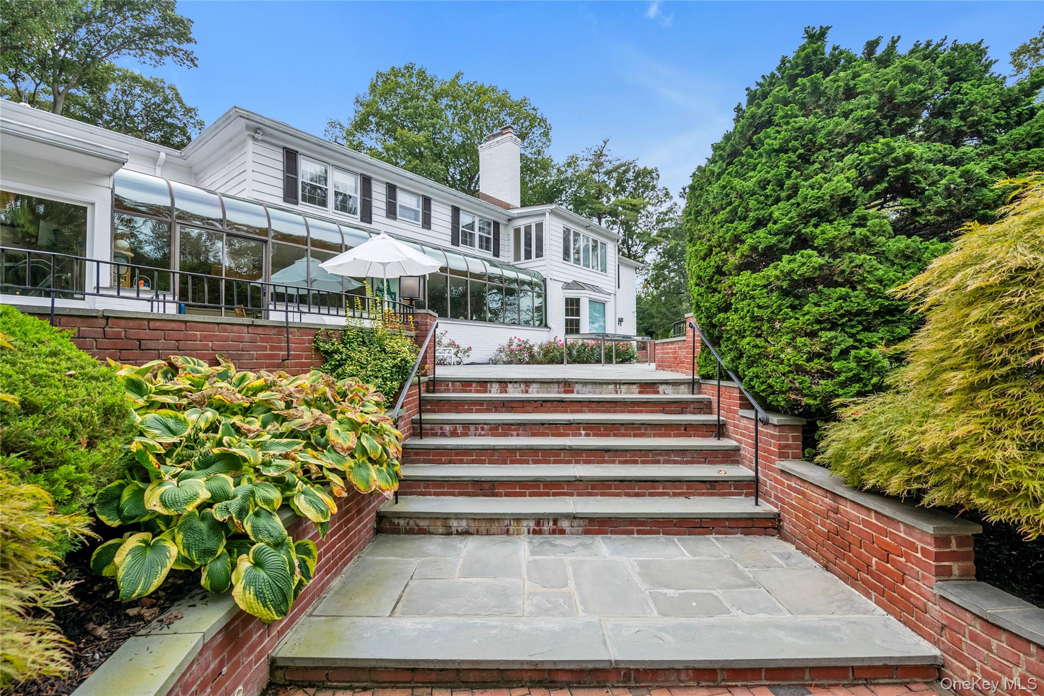 45 SE Road Sands Point, NY 11050 - Photo 23 of 36 a front view of a house with a yard