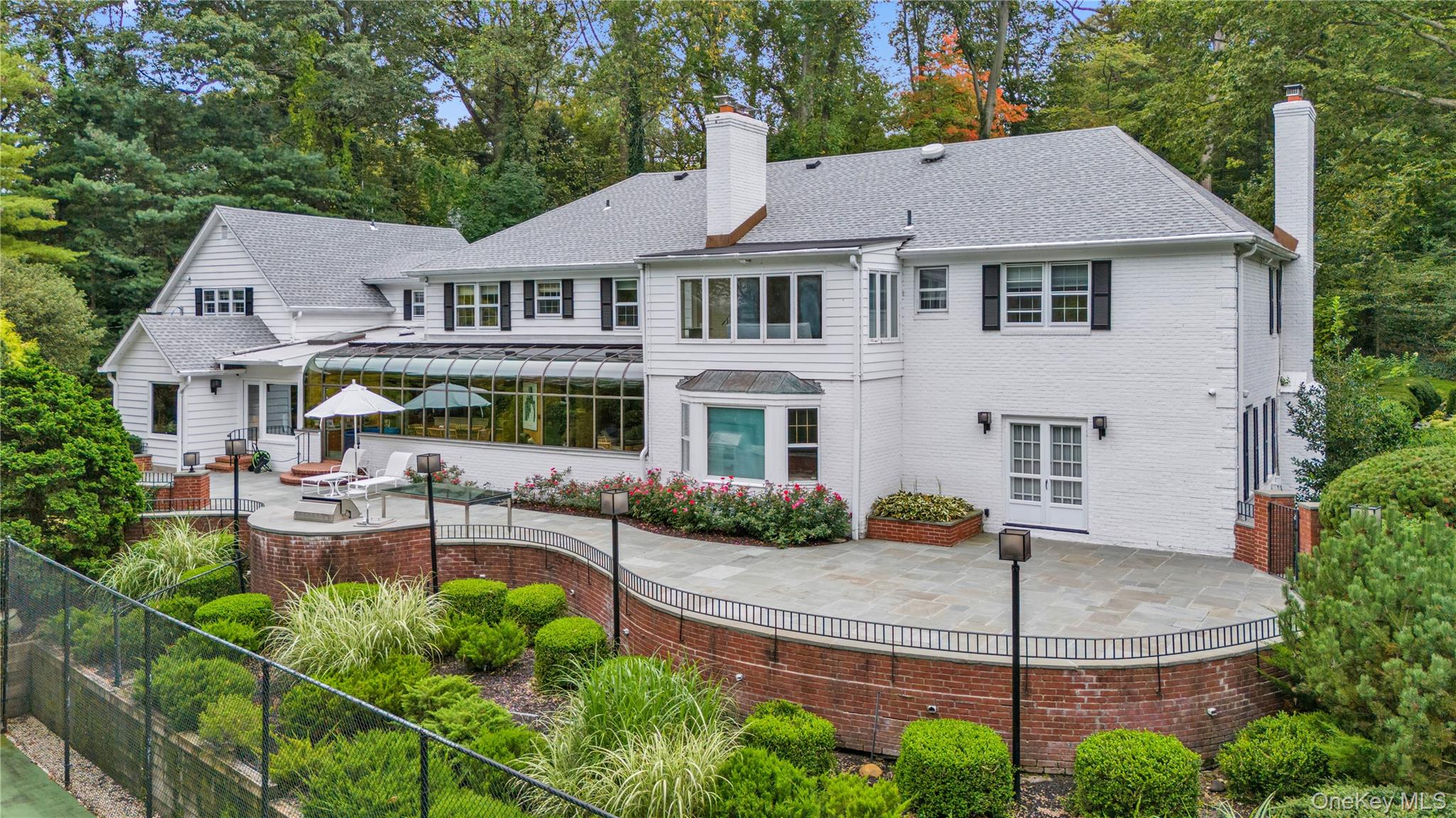 45 SE Road Sands Point, NY 11050 - Photo 25 of 36 a front view of a house with garden