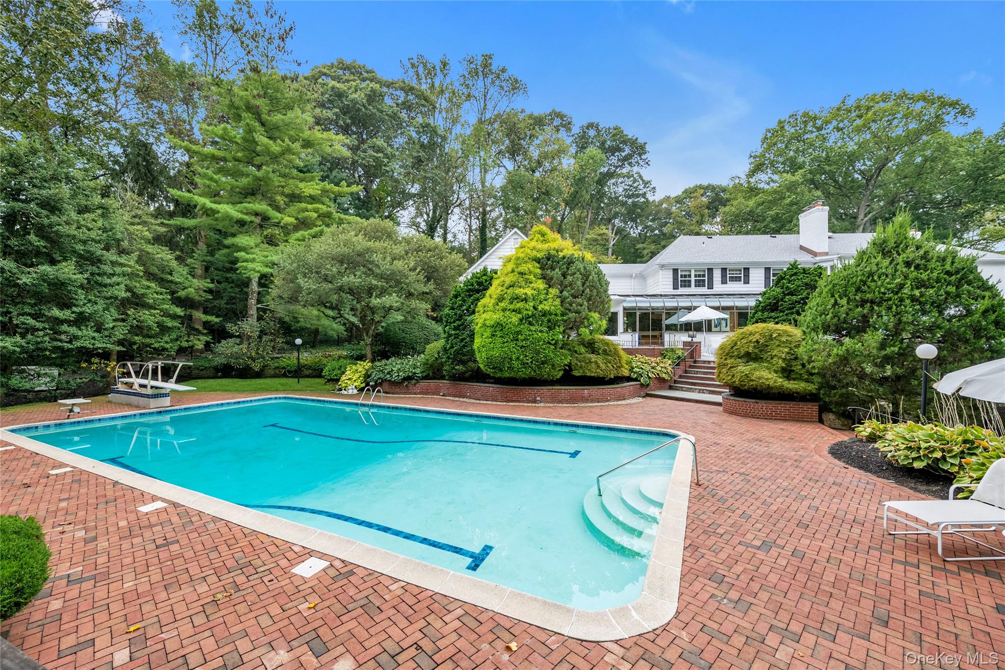 45 SE Road Sands Point, NY 11050 - Photo 30 of 36 a view of a swimming pool with a patio