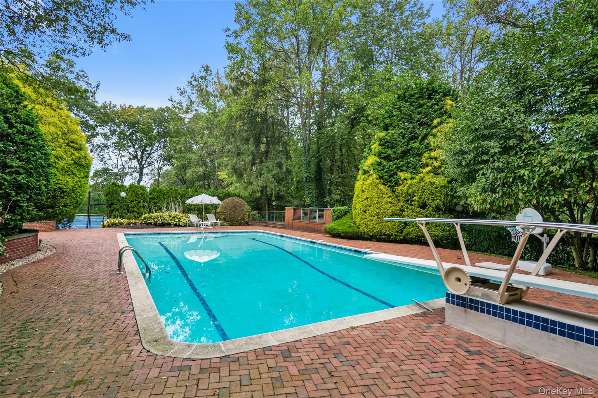 45 SE Road Sands Point, NY 11050 - Photo 31 of 36 a view of a chairs and tables in the backyard