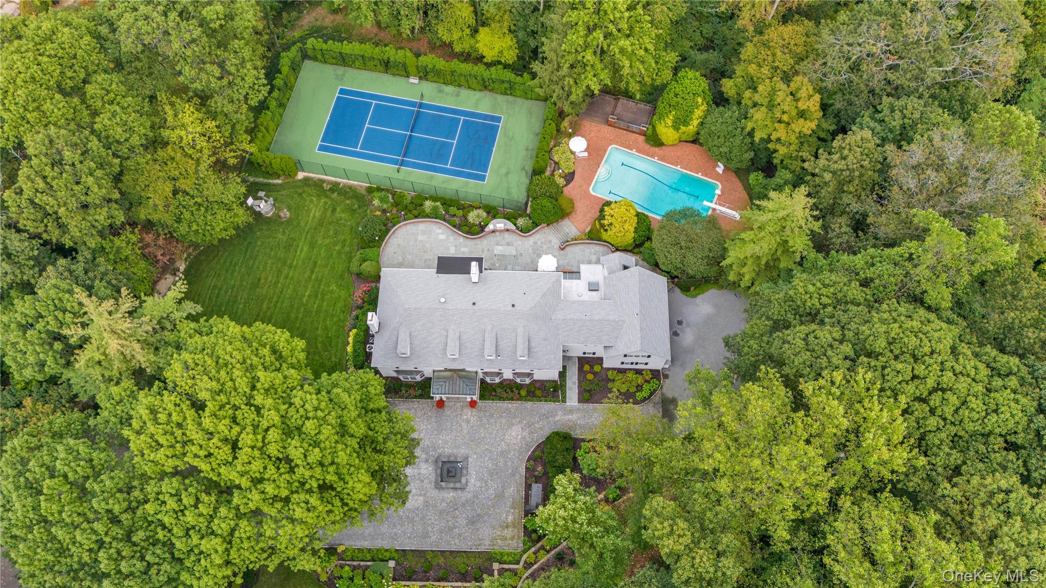 45 SE Road Sands Point, NY 11050 - Photo 33 of 36 an aerial view of a house with a yard and trees