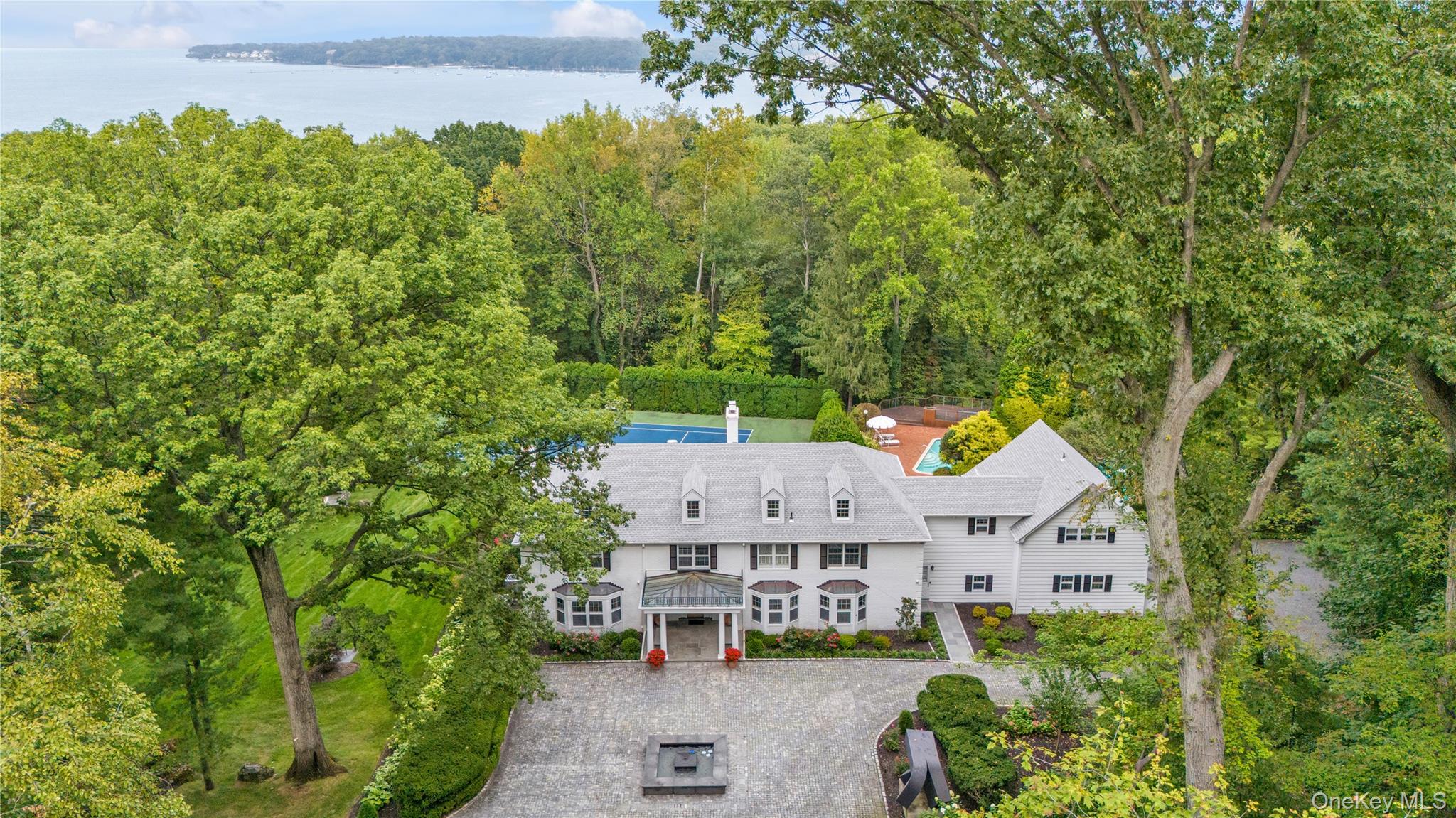 45 SE Road Sands Point, NY 11050 - Photo 34 of 36 an aerial view of a house with swimming pool and garden
