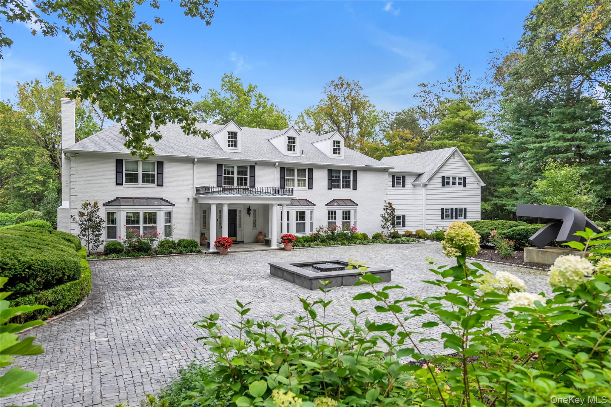 45 SE Road Sands Point, NY 11050 - Photo 36 of 36 a front view of a house with garden