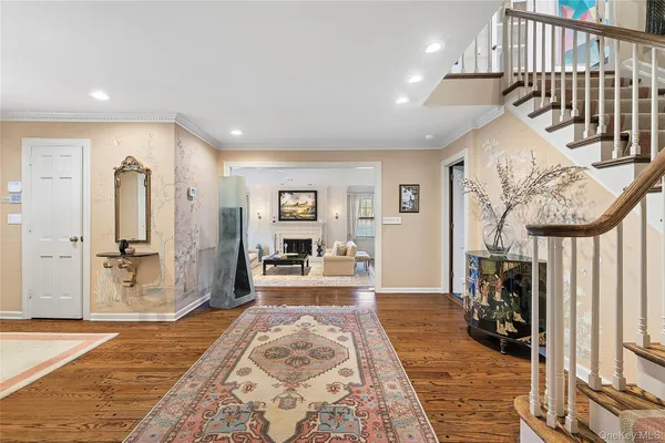 a living room with furniture a rug and a fireplace