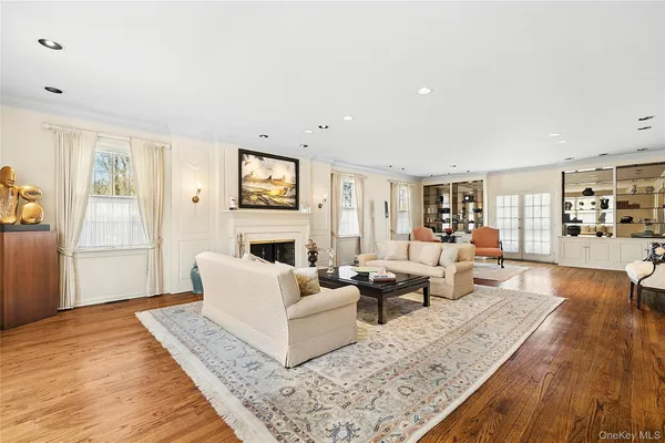 a living room with fireplace furniture and a large window