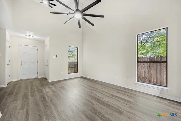 wooden floor in an empty room with a window