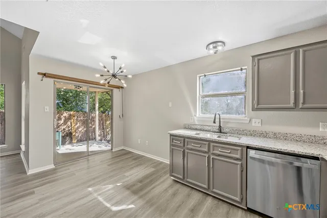 a hallway with sink and mirror