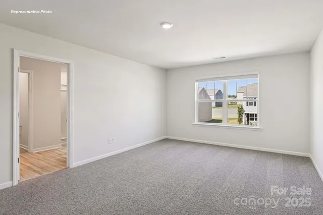 an empty room with windows and cabinet