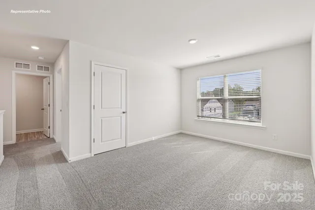 an empty room with windows and entrance