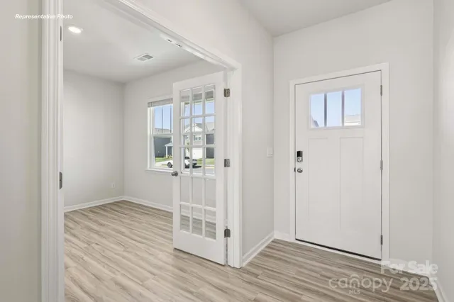 a view of wooden floor and windows in a room