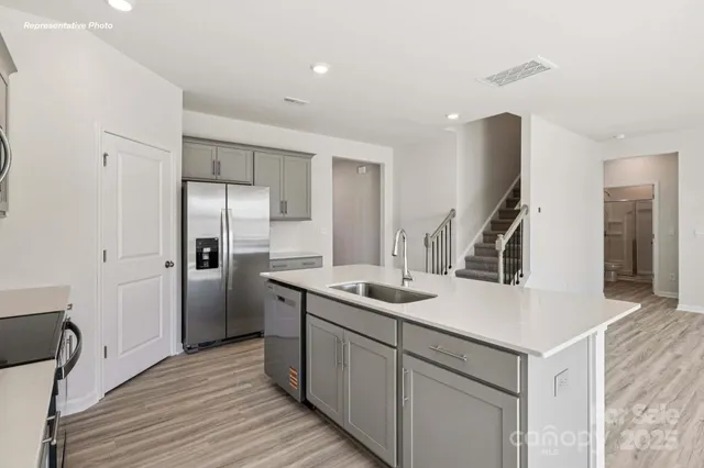 a kitchen with a sink and refrigerator