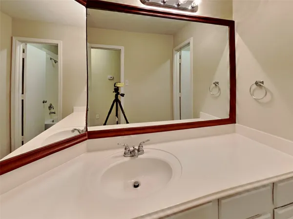 a bathroom with a sink and a large mirror