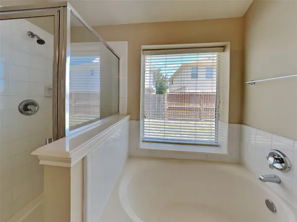 a bathroom with a bathtub and a window
