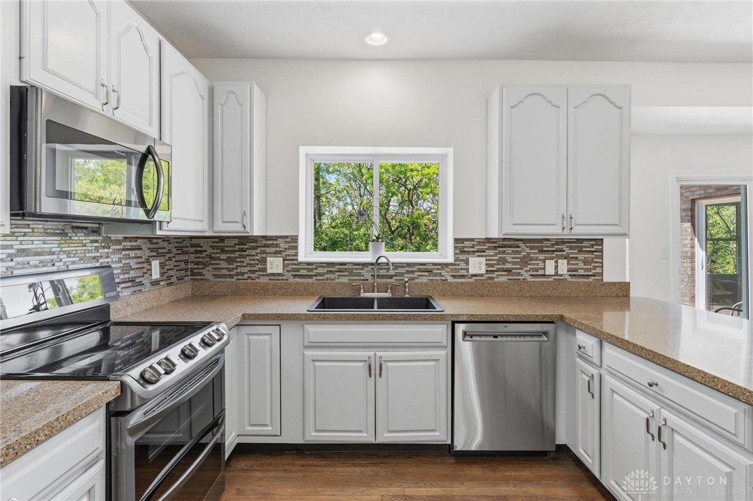 70 Martin Lane Springboro, OH 45066 - Photo 13 of 69 This bright kitchen features modern appliances and a serene window view, perfect for daily living.