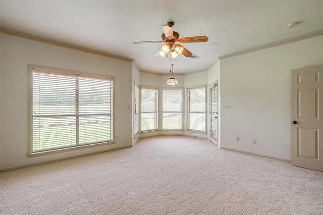 an empty room with a empty space and a ceiling fan