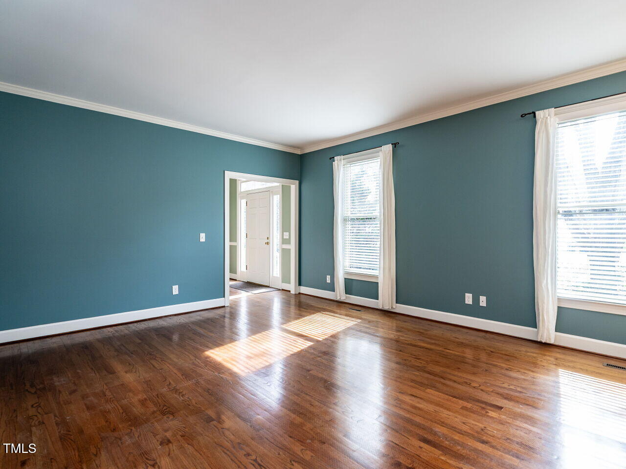 2512 Winterbury Court Raleigh, NC 27607 - Photo 8 of 34 a view of an empty room with window and wooden floor