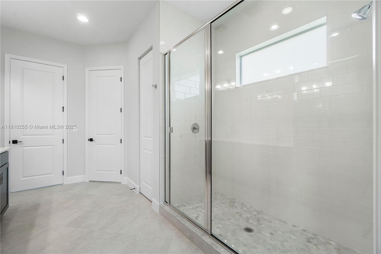 5488 Liberty Lane, Unit 5488 Westlake, FL 33470 - Photo 16 of 39 a bathroom with a shower and a glass door